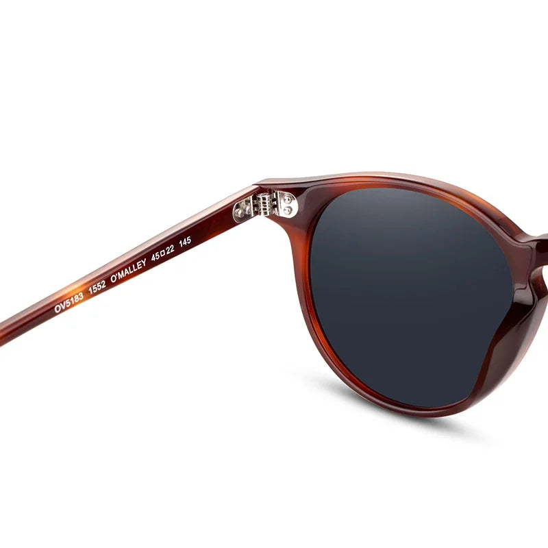 Sunglasses with tortoiseshell frame and dark lenses on a white background