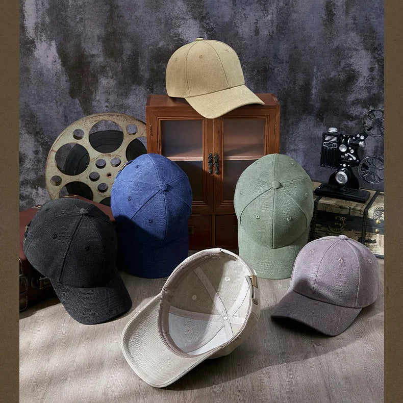 Collection of baseball caps in various colors on a textured surface with a vintage background.