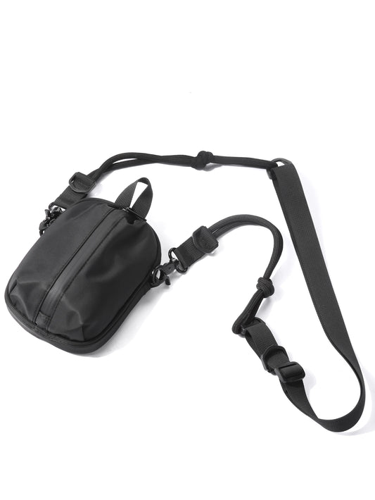 Black shoulder bag with a strap on a white background