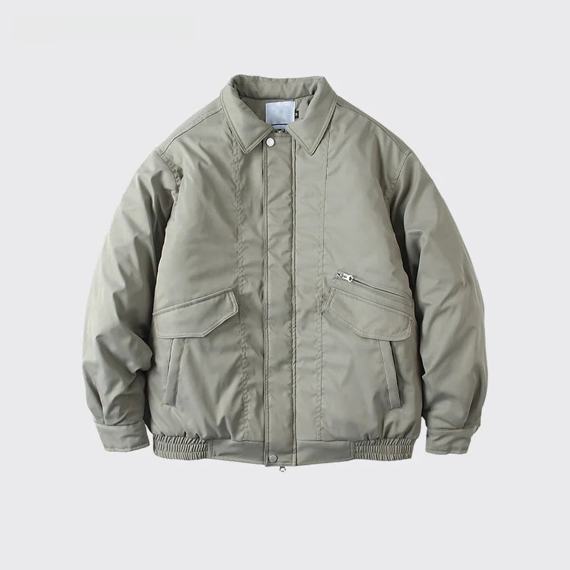 A light olive green utility jacket with a button-up front, collar, and zippered chest pocket, displayed on a light gray background with text below.