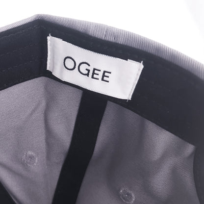 Close-up of a gray garment with a visible 'OGEE' label.