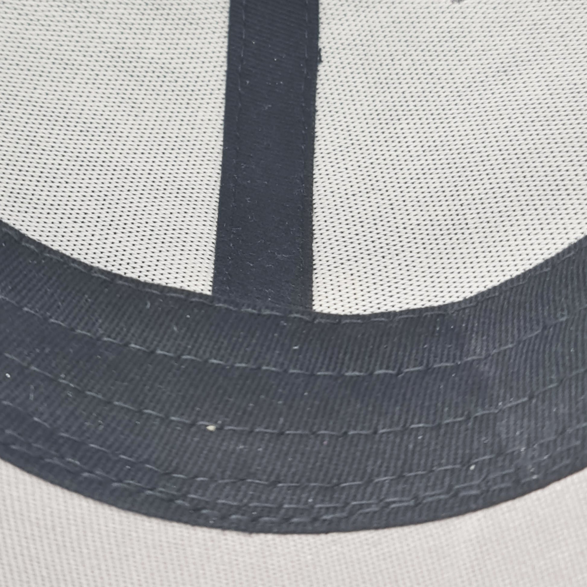 Close-up of a cap with mesh back and black band