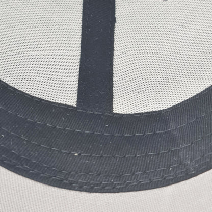 Close-up of a cap with mesh back and black band