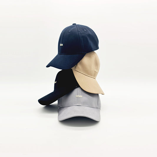 Three baseball caps in navy, beige, and gray on a white background