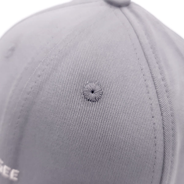 Close-up of a gray cap with a small defect on the fabric.