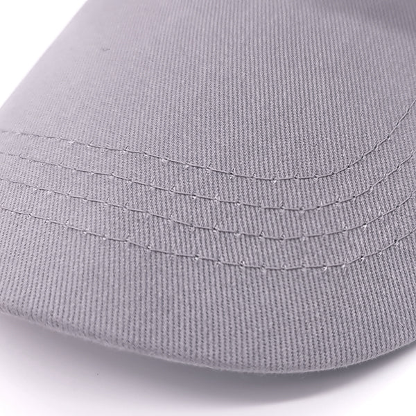 Close-up of a gray fabric surface with stitching details on a white background