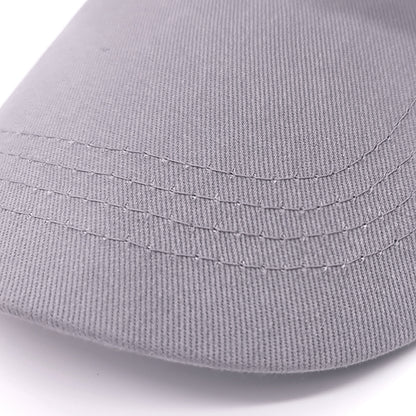 Close-up of a gray fabric surface with stitching details on a white background