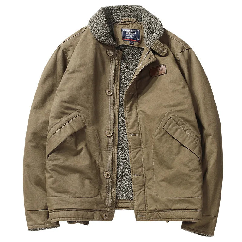 A classic brown canvas utility jacket with a gray sherpa fleece lining, featuring a button-up front, large front flap pockets, and a brown leather patch on the chest.