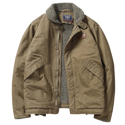 A classic brown canvas utility jacket with a gray sherpa fleece lining, featuring a button-up front, large front flap pockets, and a brown leather patch on the chest.