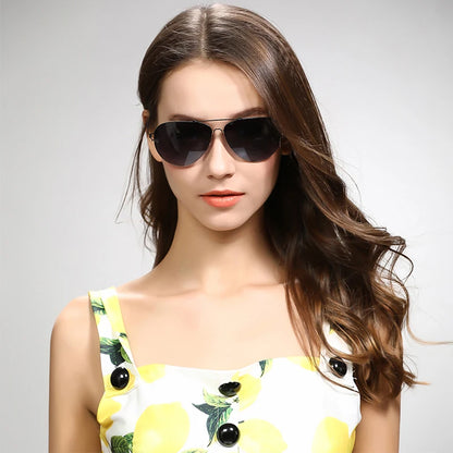 Woman wearing sunglasses with a light gray background