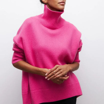 Person wearing a bright pink turtleneck sweater against a plain background