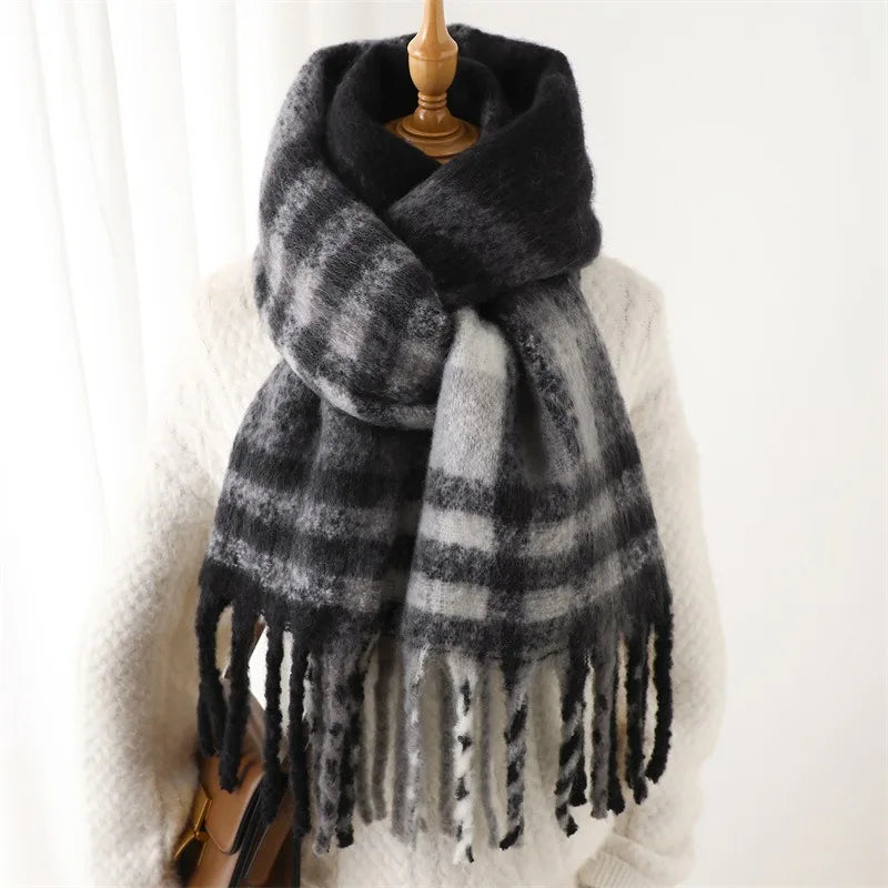 Plaid scarf with fringe on a wooden stand against a white background