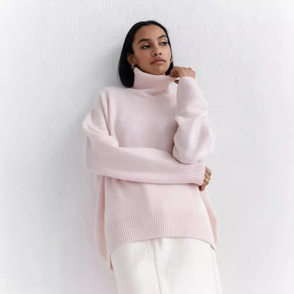 Person wearing a light pink turtleneck sweater against a white background