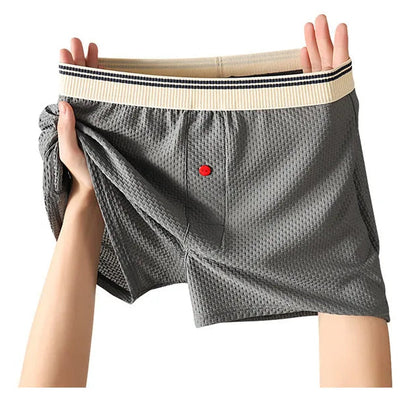 Gray cotton fashion pants held up against a white background