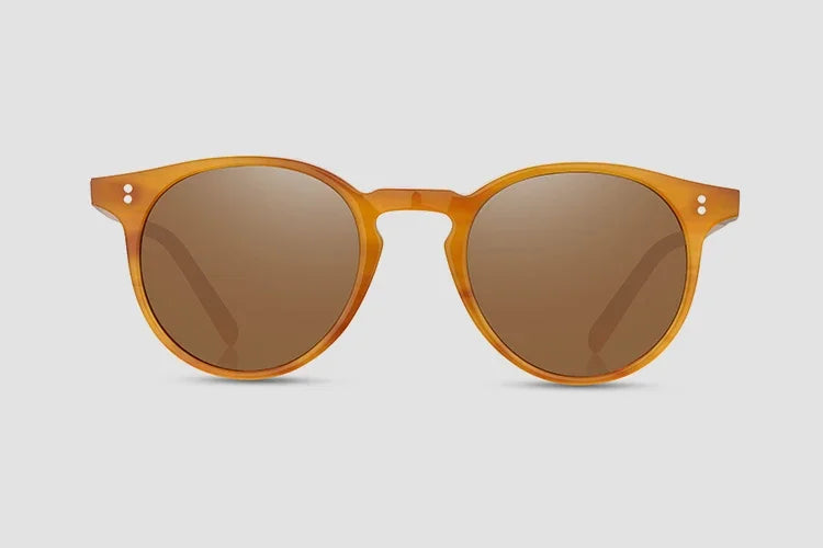 Round sunglasses with brown lenses and orange frame on a light gray background
