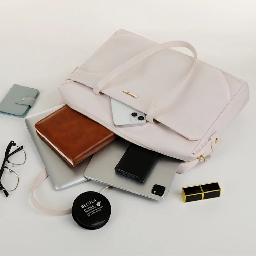 Pink backpack with items like a phone, laptop, and books on a white background