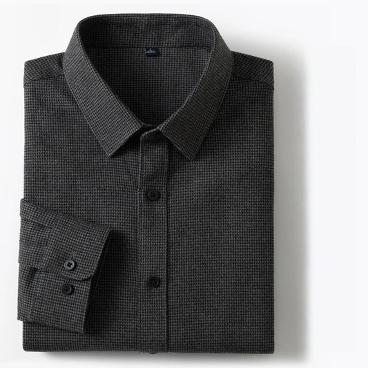 A folded dark gray micro-check patterned dress shirt with a pointed collar and button-down front, displayed on a clean white background.
