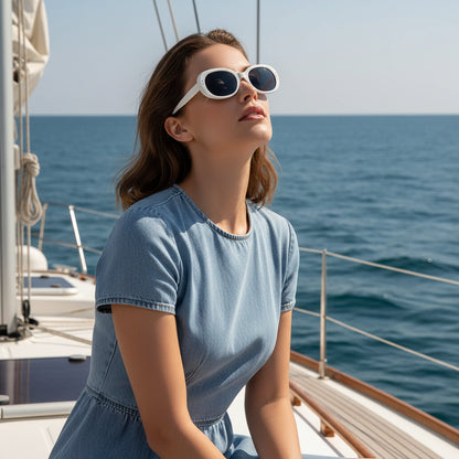 White oval sunglasses with dark lenses on a white background