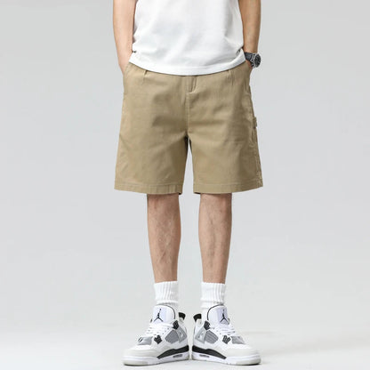 Person wearing beige shorts and white sneakers on a gray background with 'HIQOR' branding.