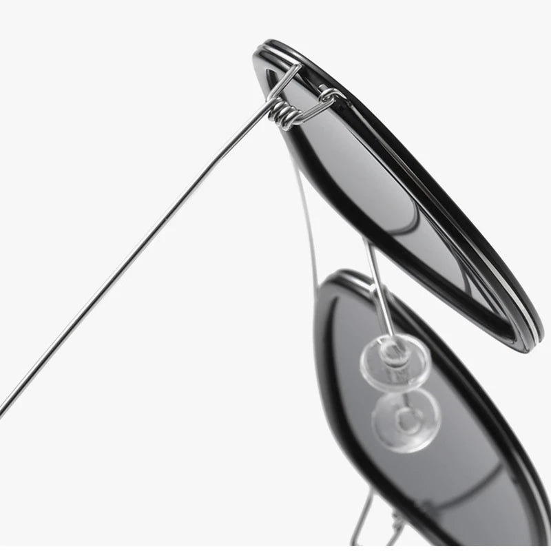 Close-up of a pair of silver earrings on a white background