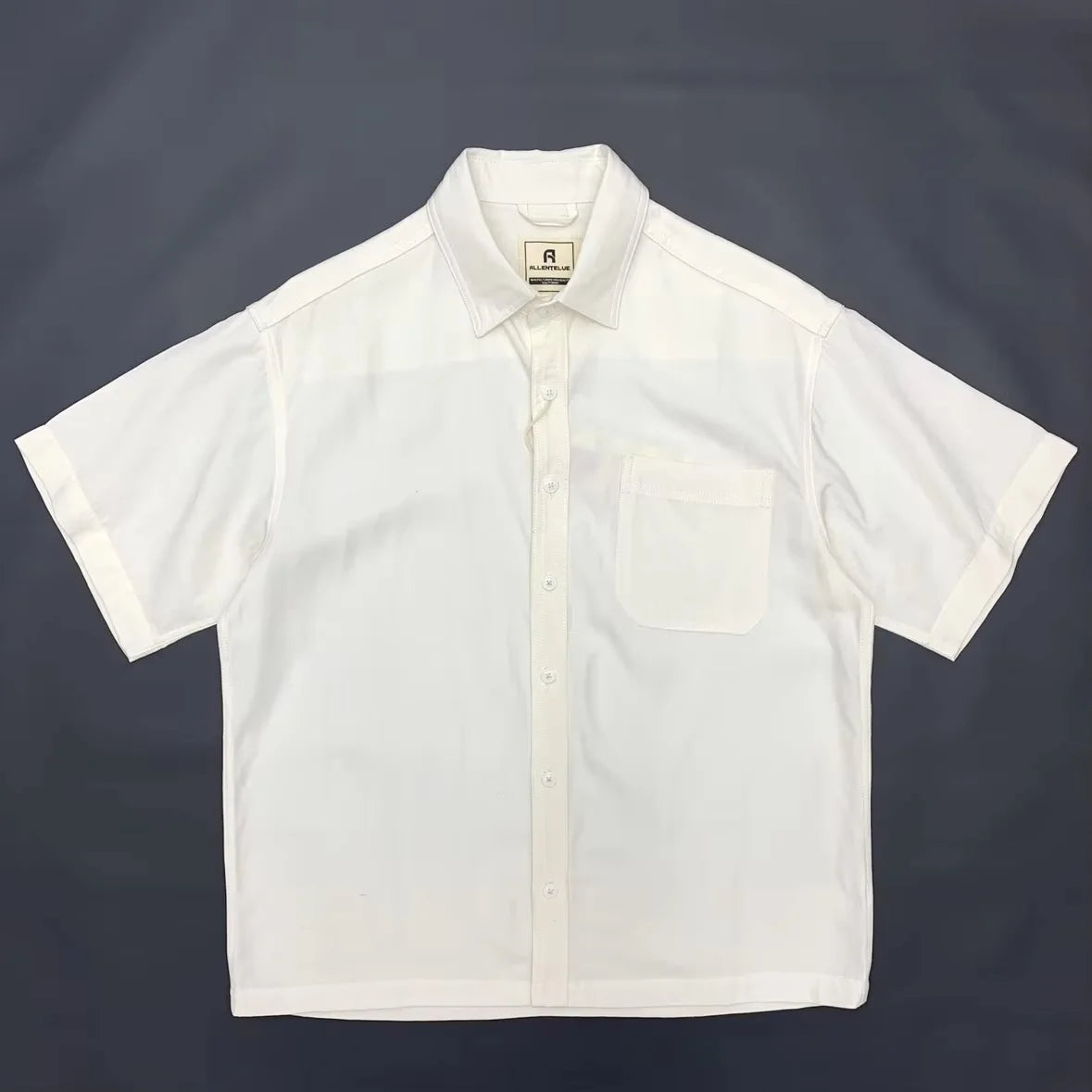 White short-sleeve shirt on a dark background