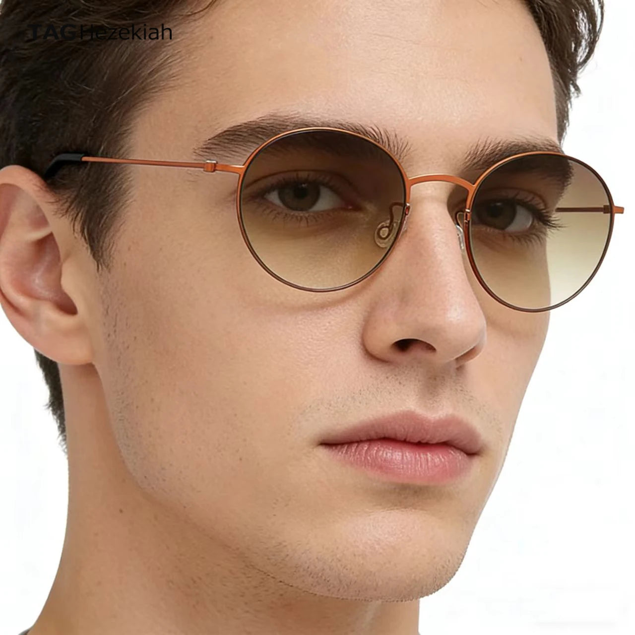 Close-up of a person wearing round sunglasses with a neutral background