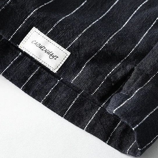 Black pinstripe fabric with a visible brand label on a white background