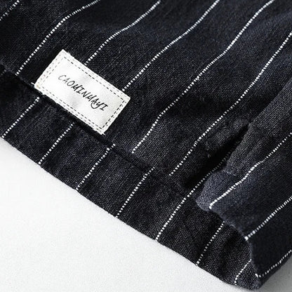 Black pinstripe fabric with a visible brand label on a white background