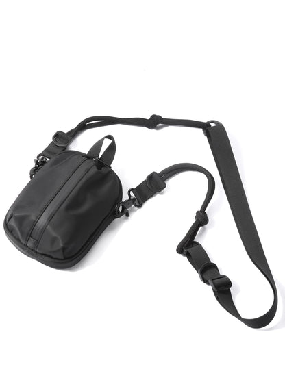Black shoulder bag with a strap on a white background