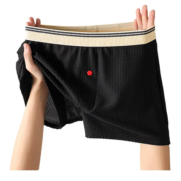 Black cotton fashion pants held up by a person on a white background with text.