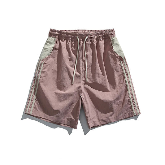 Pink shorts with green accents on a white background, presented by Basefly Official Store.