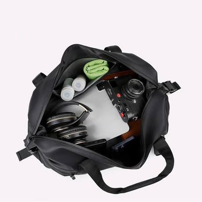 Black backpack with various items inside on a white background