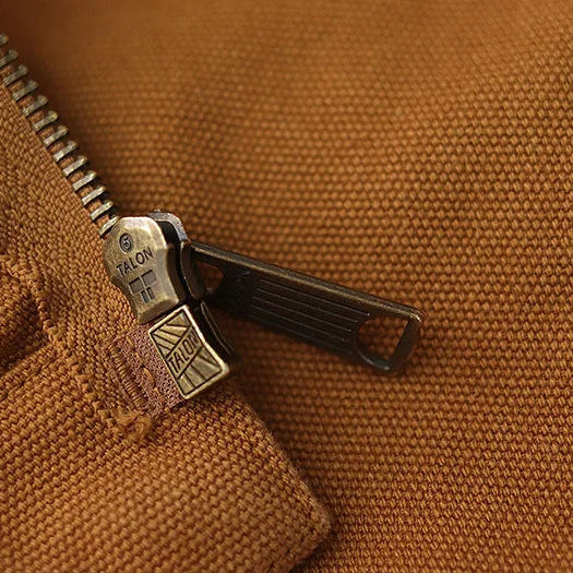 Close-up of a zipper on a brown fabric background