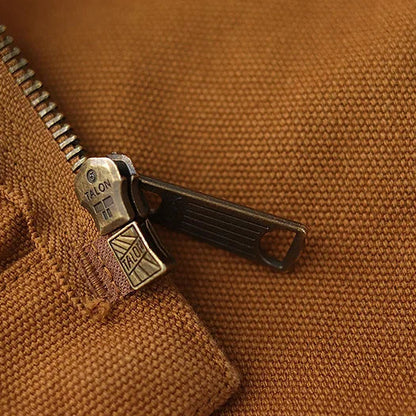 Close-up of a zipper on a brown fabric background