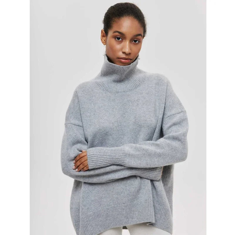 Woman wearing a gray turtleneck sweater on a light gray background