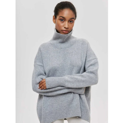 Woman wearing a gray turtleneck sweater on a light gray background