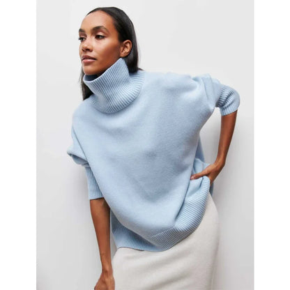 Woman wearing a light blue turtleneck sweater against a white background