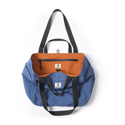 Blue and orange bag with black straps on a white background, featuring P.travel logo.