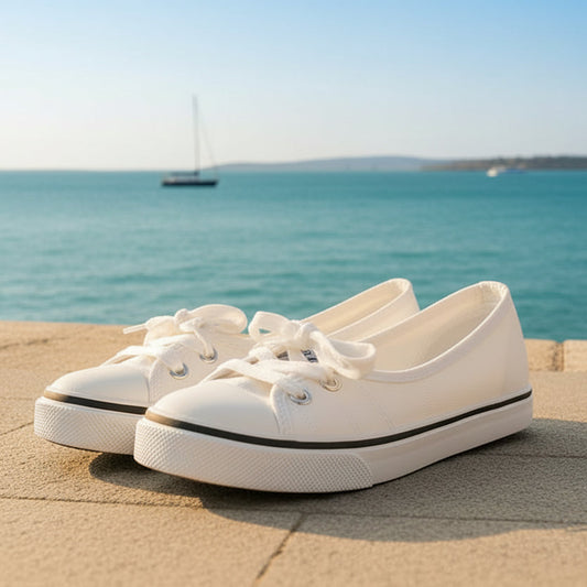 White sneakers with white soles on a gray surface