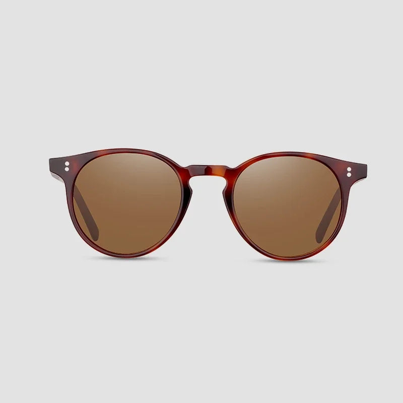 Sunglasses with a tortoiseshell frame and brown lenses on a light gray background.