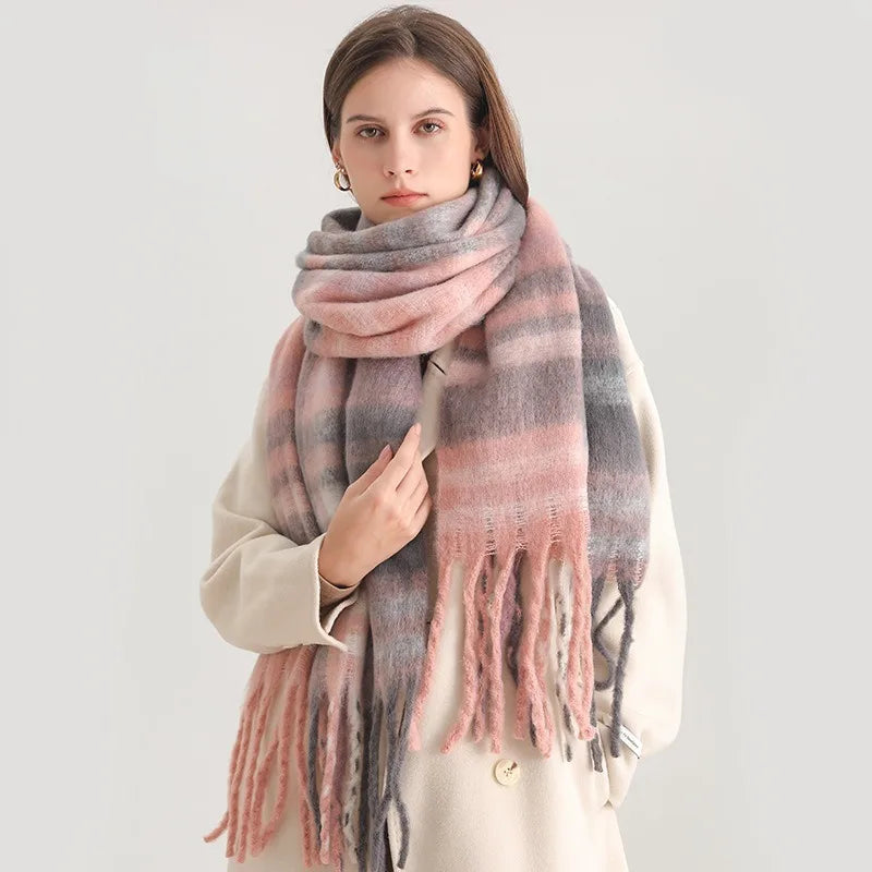 Woman wearing a pink and gray plaid scarf on a white background