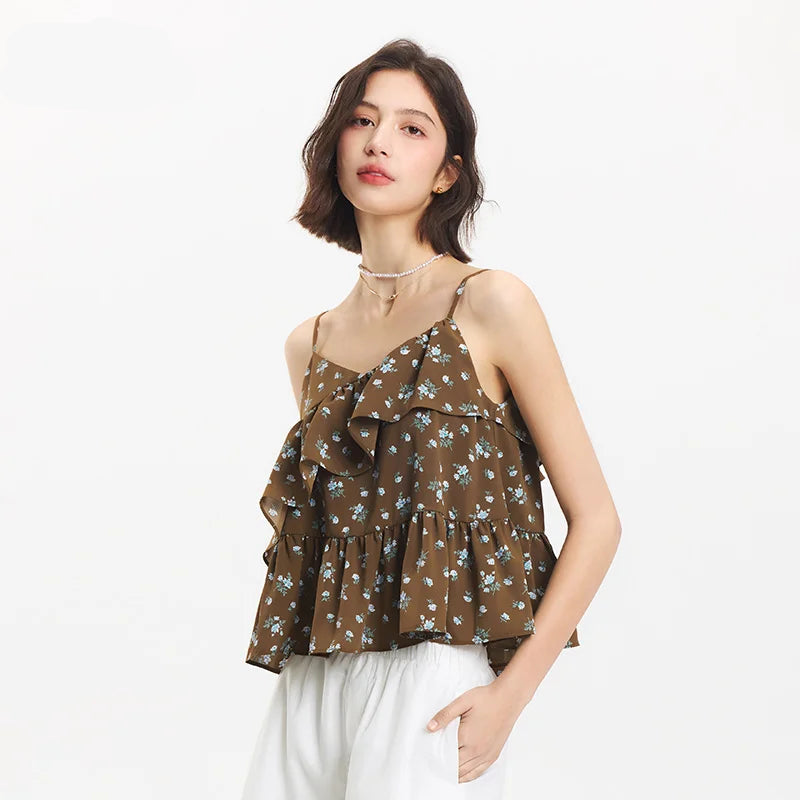 Woman wearing a brown floral top with white pants on a white background, featuring the SEMIR brand.