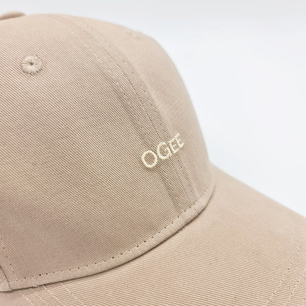 Beige cap with 'OGEE' logo on a white background