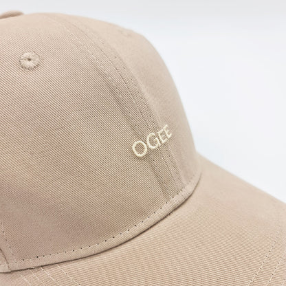 Beige cap with 'OGEE' logo on a white background